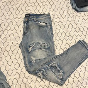 Denim blue jean, has rips and designs, and has nice stretch